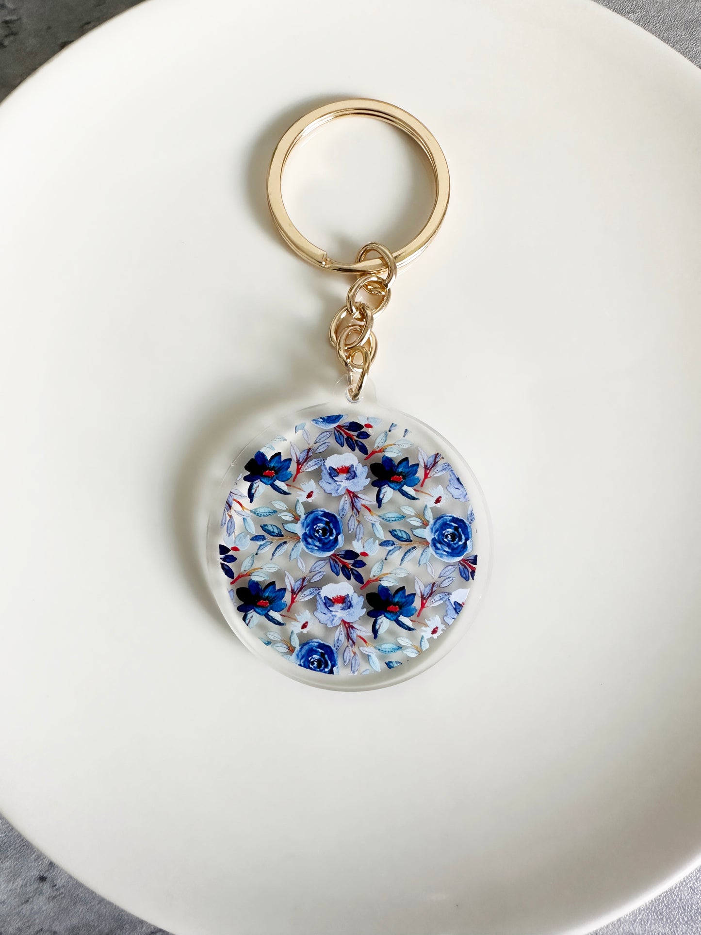 Blue floral keychain on a gold keyring