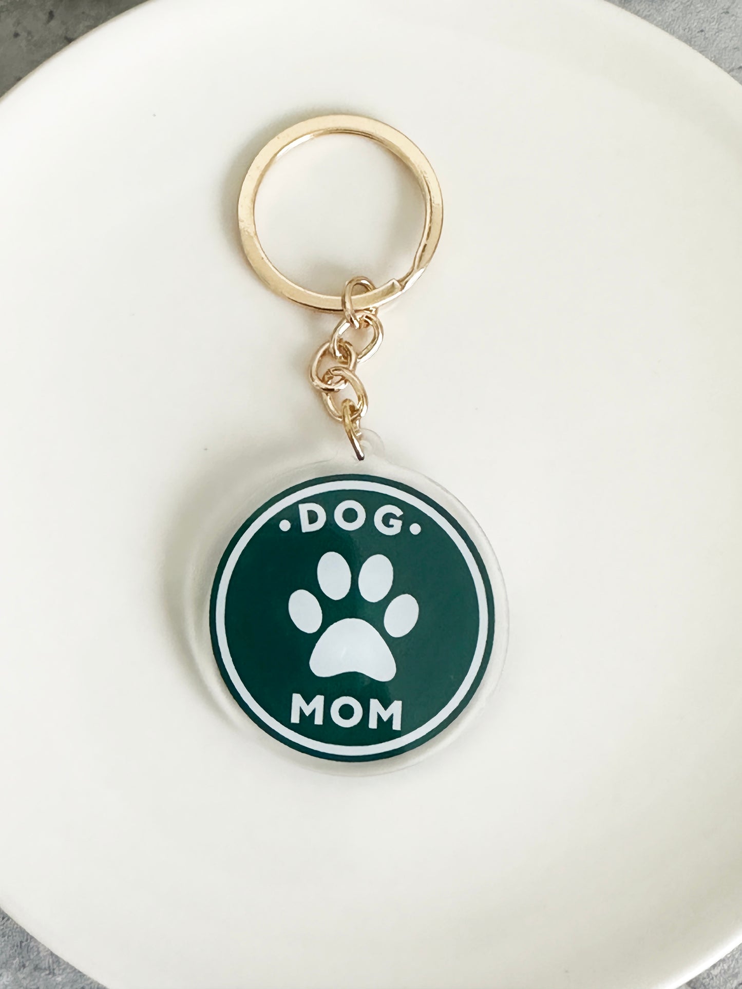 Acrylic Dog Mom Keychain with pawprint on a gold keyring
